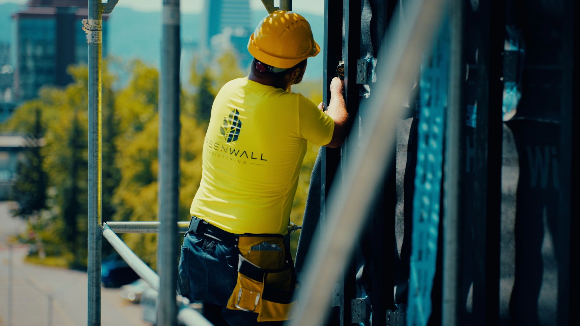 A Greenwall installer working on a facade